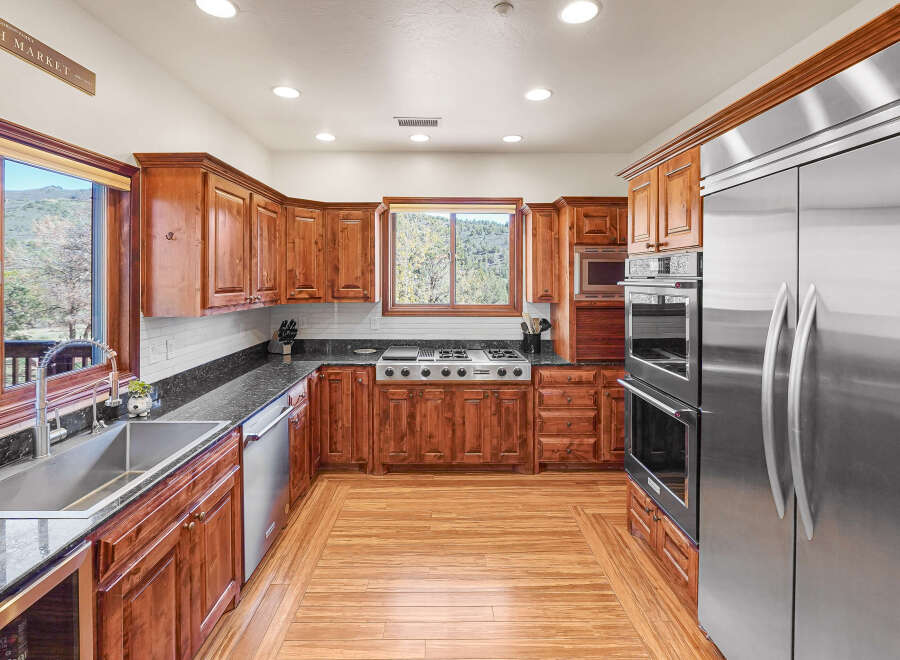 This stunning kitchen boasts custom cabinetry, stainless steel appliances, and a sleek granite countertop.