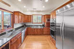 This stunning kitchen boasts custom cabinetry, stainless steel appliances, and a sleek granite countertop.