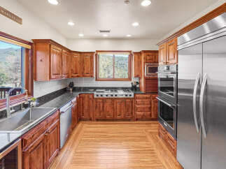 This stunning kitchen boasts custom cabinetry, stainless steel appliances, and a sleek granite countertop.