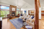 Step into luxury with this stunning living room, featuring a cozy fireplace and expansive windows that frame breathtaking views.