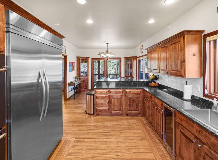 This stunning kitchen boasts custom cabinetry, granite countertops, and stainless steel appliances.