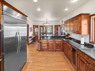 This stunning kitchen boasts custom cabinetry, granite countertops, and stainless steel appliances.
