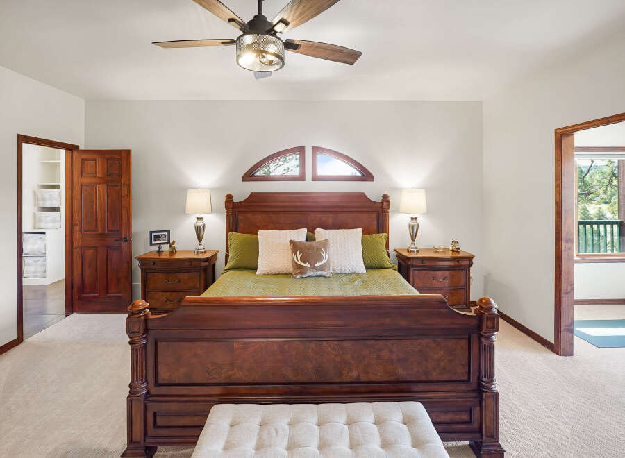 Step into luxury with this stunning bedroom, featuring a grand wooden bed as the centerpiece.
