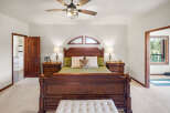 Step into luxury with this stunning bedroom, featuring a grand wooden bed as the centerpiece.