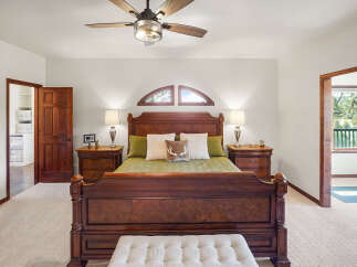 Step into luxury with this stunning bedroom, featuring a grand wooden bed as the centerpiece.