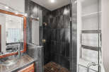 Step into luxury with this stunning bathroom featuring a modern shower design.