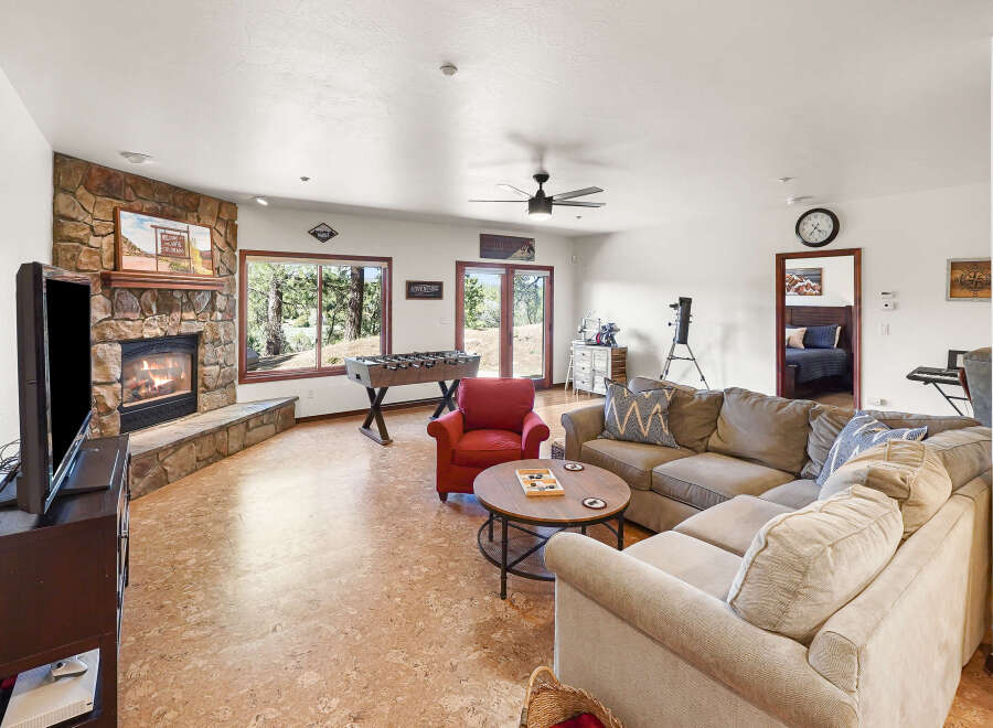 Step into this inviting living space, featuring a cozy fireplace and a comfortable sectional sofa, perfect for relaxing evenings.