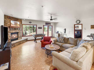 Step into this inviting living space, featuring a cozy fireplace and a comfortable sectional sofa, perfect for relaxing evenings.