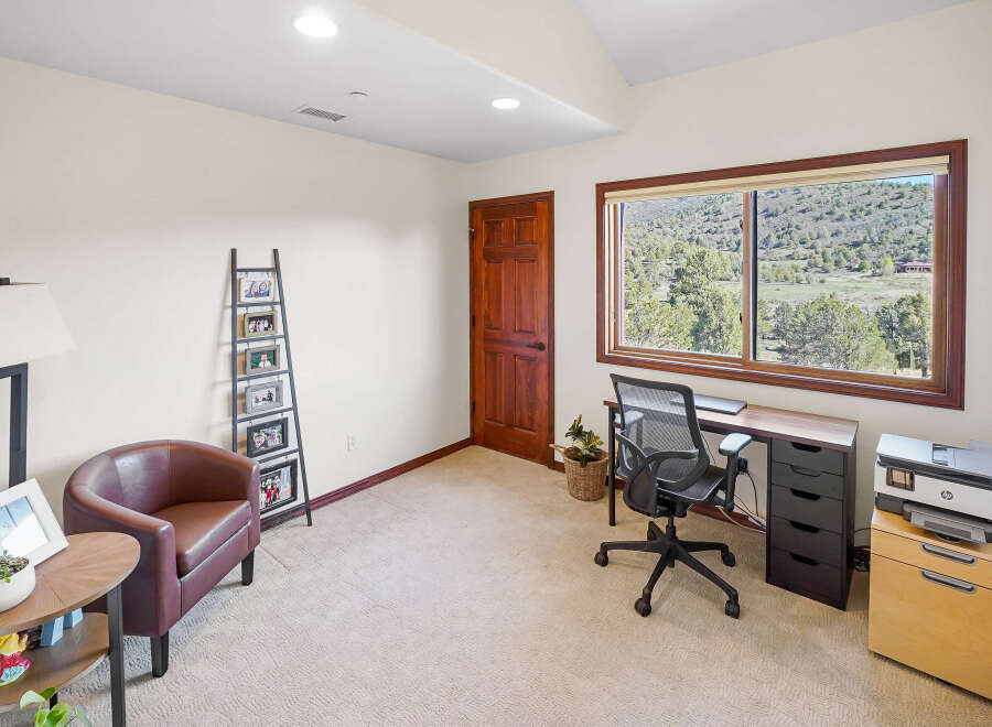 This inviting home office features a comfortable armchair and a stylish desk, perfect for productivity.