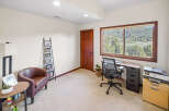 This inviting home office features a comfortable armchair and a stylish desk, perfect for productivity.