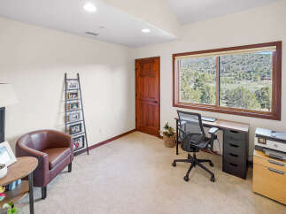 This inviting home office features a comfortable armchair and a stylish desk, perfect for productivity.