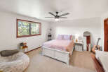 This inviting bedroom boasts a cozy atmosphere with its plush bedding and soft color palette.