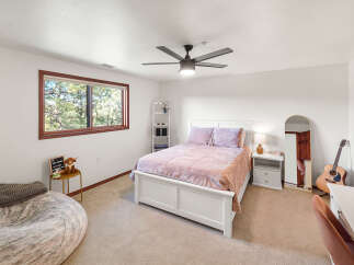 This inviting bedroom boasts a cozy atmosphere with its plush bedding and soft color palette.