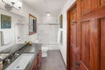 Step into this inviting bathroom, featuring a sleek vanity with a dark countertop and a pristine white sink.