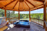 Relax and unwind in this stunning outdoor spa, nestled under a beautiful wooden gazebo.