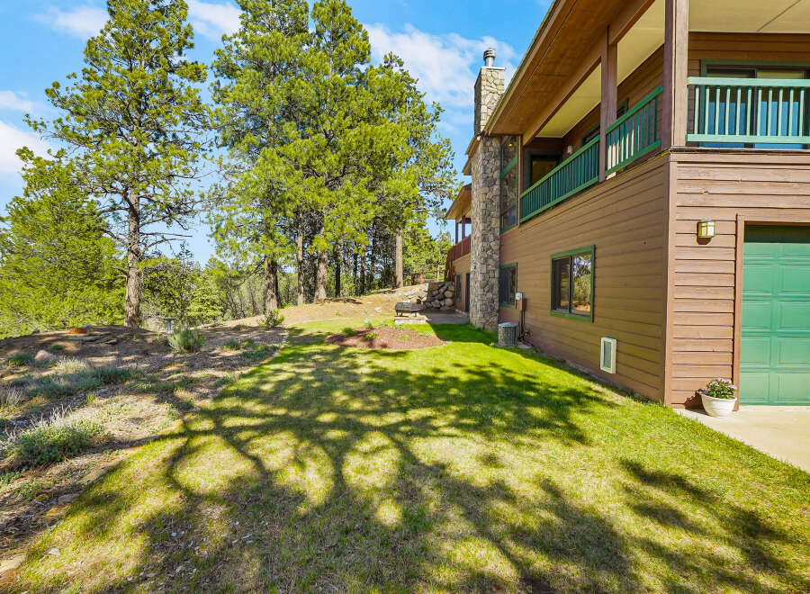 Nestled amidst lush greenery, this stunning property boasts a charming exterior with a blend of natural elements.