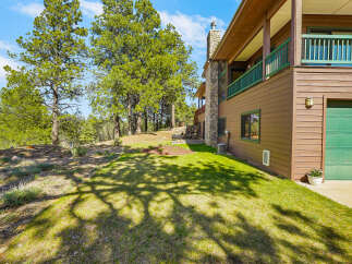 Nestled amidst lush greenery, this stunning property boasts a charming exterior with a blend of natural elements.