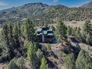 Nestled amidst a serene forest landscape, this magnificent home offers a perfect blend of rustic charm and modern comfort.
