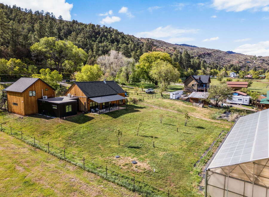 Discover your dream property in this stunning rural setting! This expansive estate boasts a charming main house, a detached structure, and a greenhouse, perfect for the hobbyist or entrepreneur.