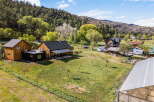 Discover your dream property in this stunning rural setting! This expansive estate boasts a charming main house, a detached structure, and a greenhouse, perfect for the hobbyist or entrepreneur.