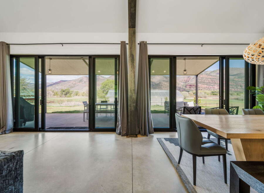Experience luxury living with this stunning property featuring expansive windows that frame breathtaking mountain views.