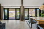 Experience luxury living with this stunning property featuring expansive windows that frame breathtaking mountain views.