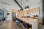 This stunning kitchen boasts a modern design with sleek cabinetry and a spacious island, perfect for both cooking and entertaining.