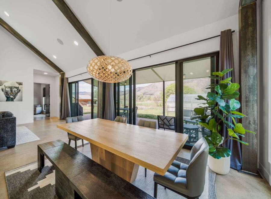 Experience luxury living in this stunning property, featuring a spacious dining area perfect for entertaining.
