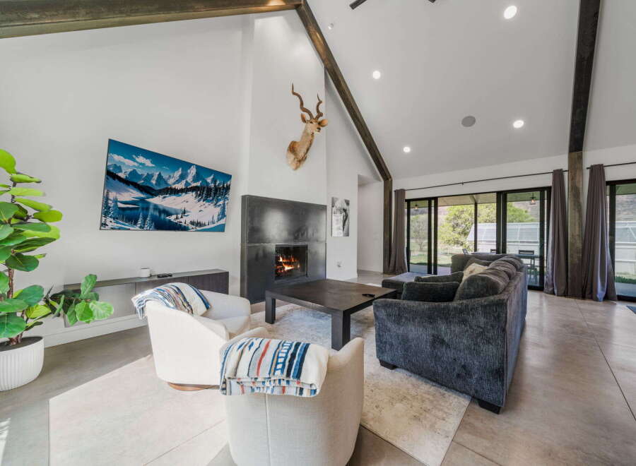 Experience luxury living in this stunning property featuring a modern fireplace and high ceilings.