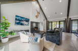 Experience luxury living in this stunning property featuring a modern fireplace and high ceilings.