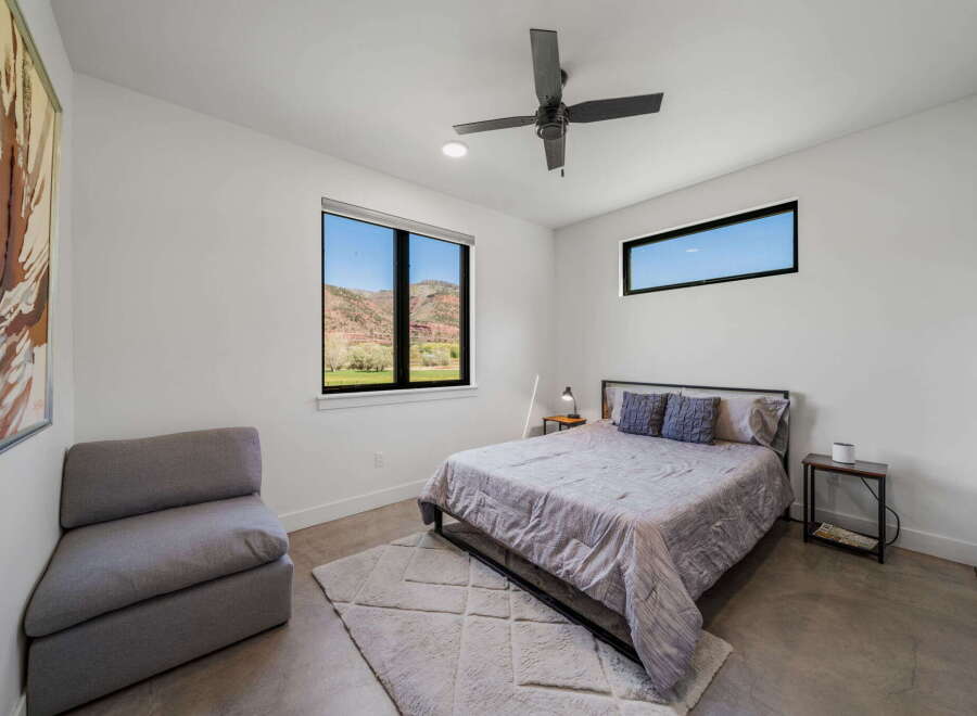 This modern bedroom boasts a minimalist design with clean lines and ample natural light.