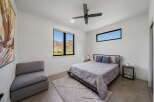 This modern bedroom boasts a minimalist design with clean lines and ample natural light.