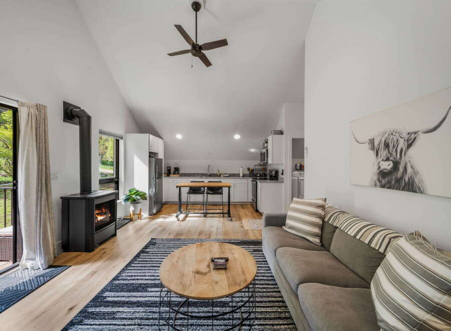 Experience cozy living in this charming home featuring a modern fireplace and a stylish kitchen.