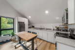 This modern kitchen boasts a sleek design with white cabinetry and a stunning marble countertop.
