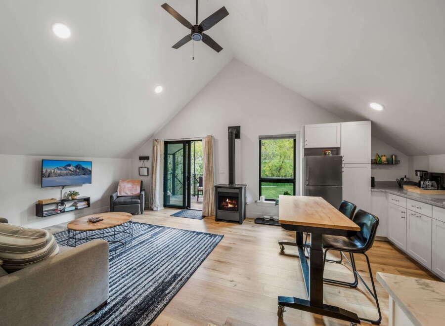 This stunning property boasts a modern open-concept living space with a cozy fireplace, perfect for relaxing evenings.