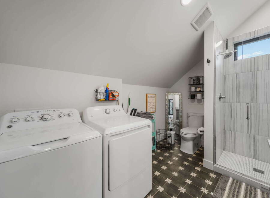 This stunning property boasts a modern laundry room and bathroom combination, perfect for maximizing space and functionality.