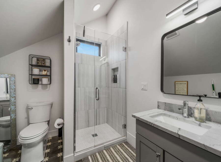 Step into this beautifully designed bathroom featuring a modern glass shower and stylish vanity.