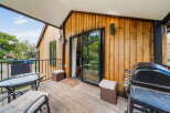 Enjoy outdoor living at its finest with this stunning deck featuring a built-in grill and comfortable seating.