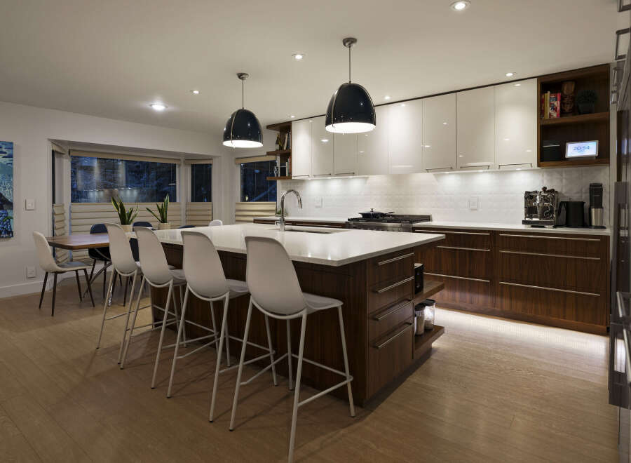 This stunning kitchen boasts a modern design with sleek cabinetry and a spacious island, perfect for both cooking and entertaining.