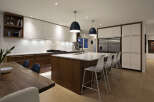 This stunning kitchen boasts modern design with sleek white cabinetry and warm wood accents.