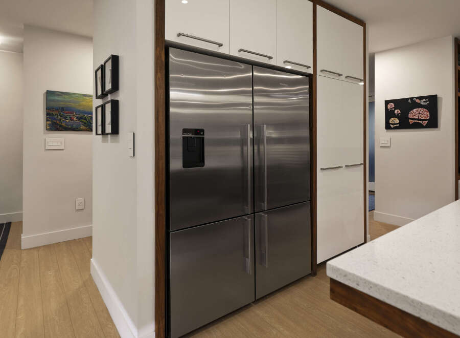 This modern kitchen boasts a sleek design with stainless steel appliances and ample storage.