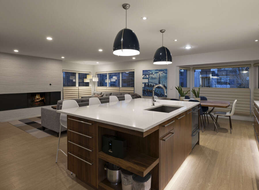 This stunning modern kitchen boasts a spacious island with a sleek countertop, perfect for meal prep and entertaining.