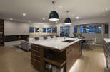 This stunning modern kitchen boasts a spacious island with a sleek countertop, perfect for meal prep and entertaining.