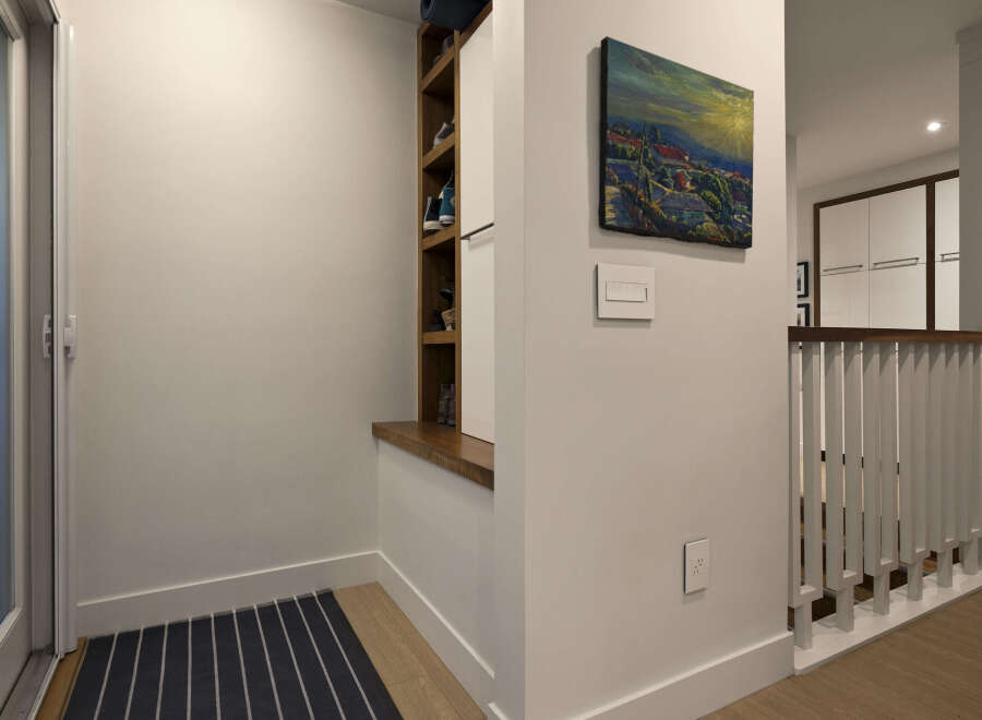 This stunning property features a modern entryway with a built-in shoe storage unit, perfect for keeping your space organized.