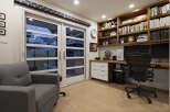 Step into this stylish home office, featuring a built-in desk and shelving, perfect for productivity.
