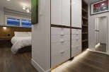 This stunning bedroom boasts a modern design with sleek, white cabinetry and rich, dark wood flooring.
