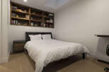 This cozy bedroom features a built-in bookshelf, perfect for displaying your favorite books and decor.