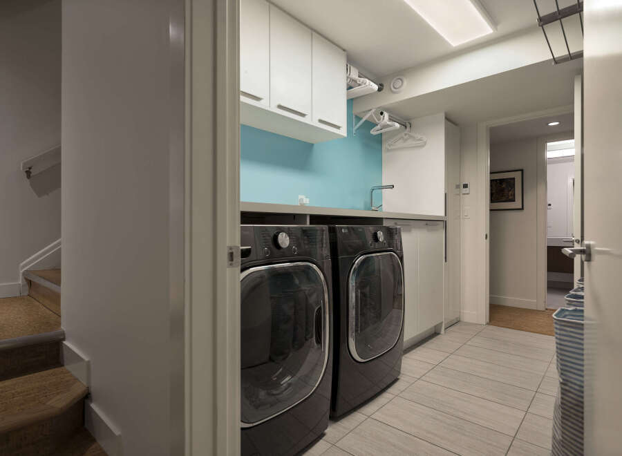 This modern laundry room offers a sleek and functional design, perfect for any home.