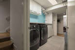 This modern laundry room offers a sleek and functional design, perfect for any home.