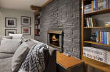 This cozy living space features a stunning stone fireplace, perfect for creating a warm and inviting atmosphere.